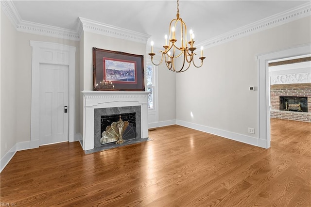 2652 Benefit Rd, Chesapeake, VA 23322 - unfurnished living room featuring a fireplace, a chandelier, ornamental molding, wood finished floors, and healthy amount of natural light