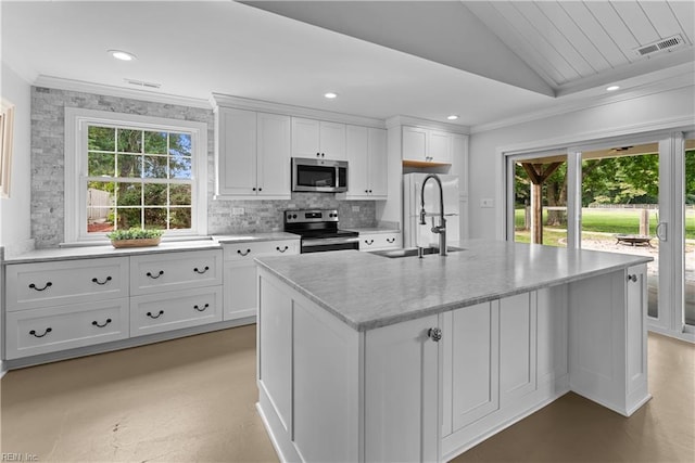 2652 Benefit Rd, Chesapeake, VA 23322 - kitchen featuring appliances with stainless steel finishes, vaulted ceiling, plenty of natural light, an island with sink, and crown molding