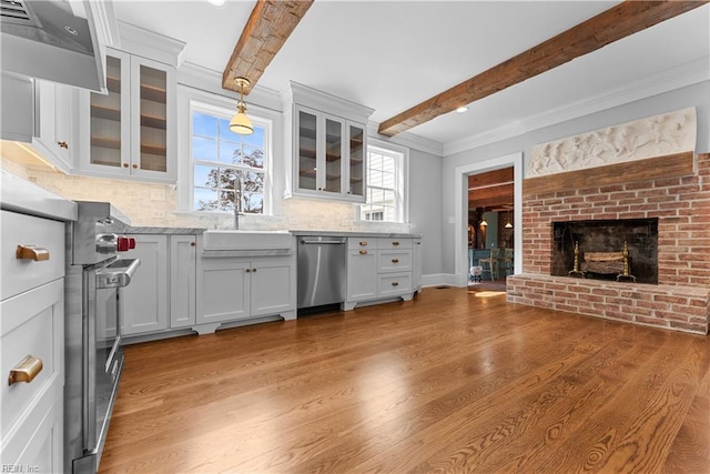 2652 Benefit Rd, Chesapeake, VA 23322 - kitchen featuring stainless steel appliances, beamed ceiling, light wood-style floors, range hood, and a fireplace