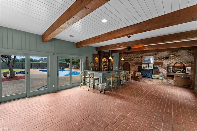 2652 Benefit Rd, Chesapeake, VA 23322 - indoor bar featuring brick patterned floors, brick wall, beam ceiling, a ceiling fan, and wooden walls