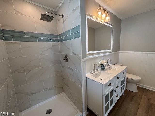 913 B St, Virginia Beach, VA 23451 - full bathroom with wood finished floors, a tile shower, toilet, double vanity, and wainscoting
