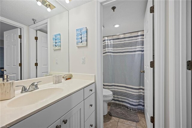 7501 River Rd Unit 4A, Newport News, VA 23607 - bathroom with toilet, vanity, a textured ceiling, tile patterned flooring, and a shower with shower curtain