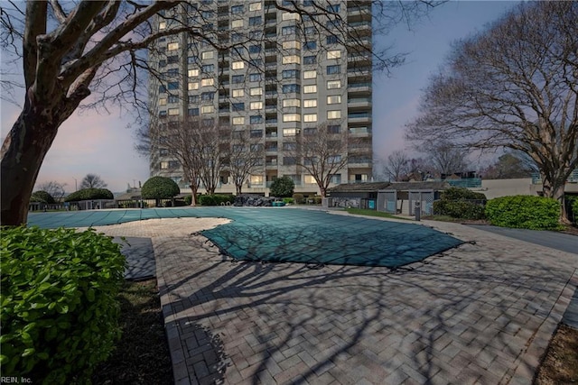 7501 River Rd Unit 4A, Newport News, VA 23607 - pool at dusk featuring a community pool and a patio area