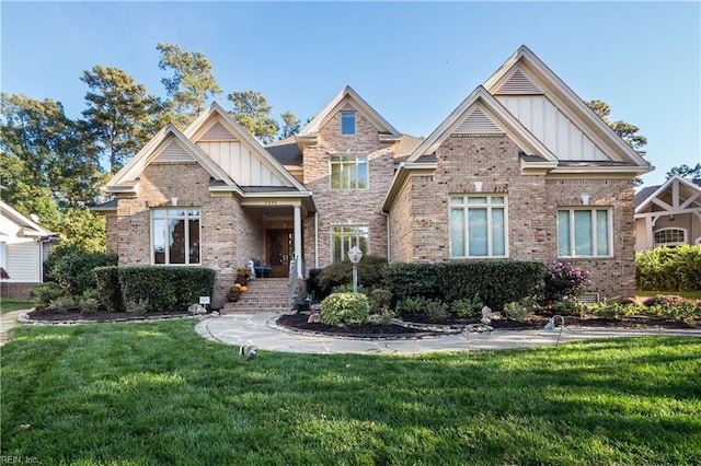 5225 Regatta Pointe Rd, Suffolk, VA 23435 - craftsman-style house with board and batten siding, brick siding, and a front lawn