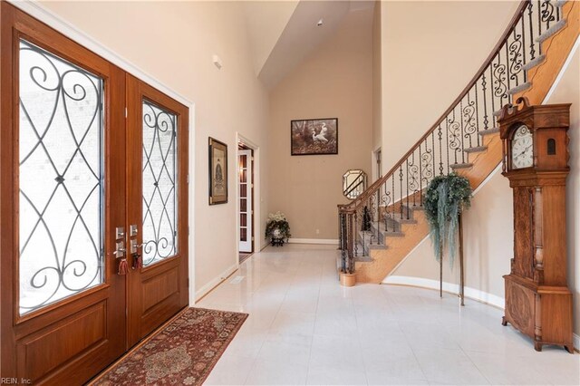 5225 Regatta Pointe Rd, Suffolk, VA 23435 - foyer with baseboards, stairs, high vaulted ceiling, tile patterned flooring, and french doors