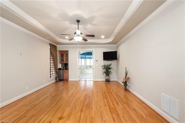 5225 Regatta Pointe Rd, Suffolk, VA 23435 - unfurnished living room with a raised ceiling, a ceiling fan, light wood-style floors, ornamental molding, and baseboards