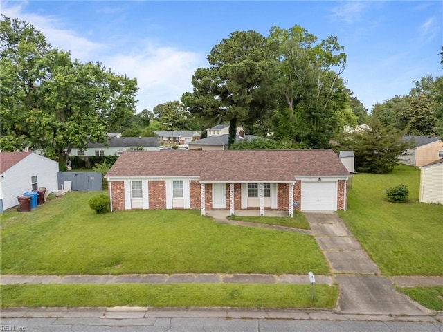 1120 Sean Dr, Chesapeake, VA 23323 - ranch-style house featuring brick siding, an attached garage, a front yard, and driveway