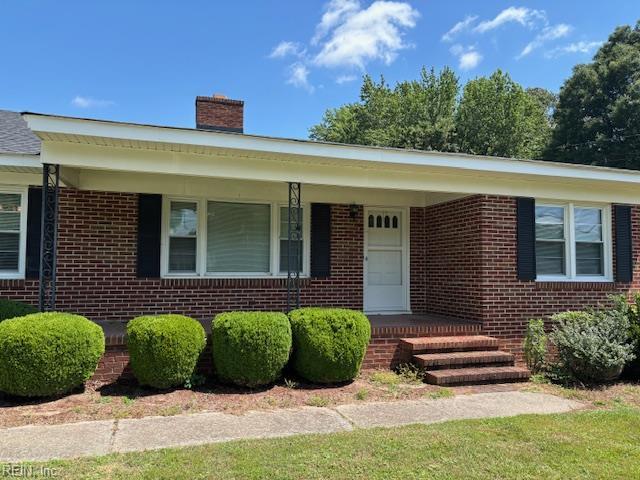 208 Country Club Rd, Franklin, VA 23851 - view of front of home with brick siding, a chimney, and covered porch