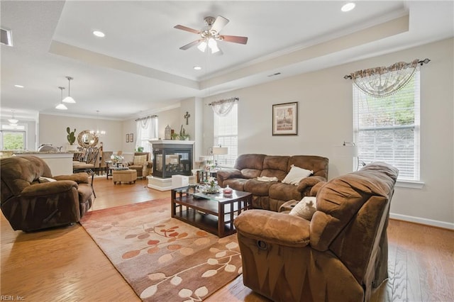 2972 Elegance Ln, Virginia Beach, VA 23456 - living room with a tray ceiling, crown molding, a ceiling fan, light wood-type flooring, and recessed lighting