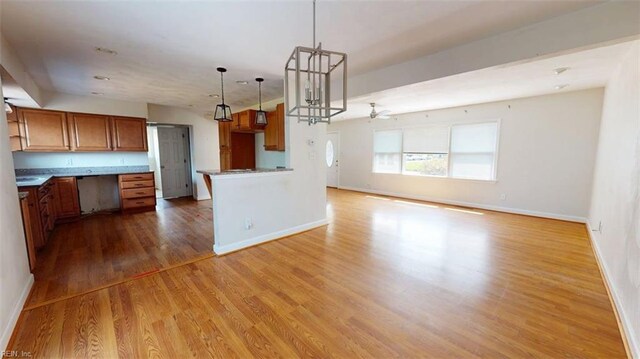 400 Ticonderoga Rd, Virginia Beach, VA 23462 - kitchen with wood finished floors, brown cabinetry, open floor plan, hanging light fixtures, and a ceiling fan