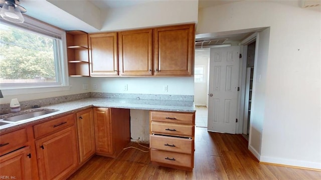 400 Ticonderoga Rd, Virginia Beach, VA 23462 - kitchen featuring light wood-style flooring, brown cabinets, light stone counters, and open shelves
