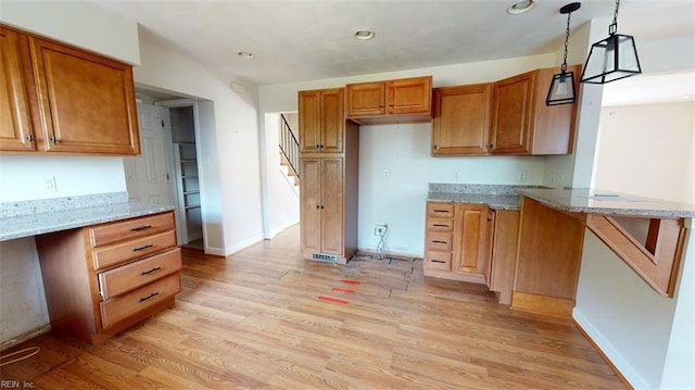 400 Ticonderoga Rd, Virginia Beach, VA 23462 - kitchen with brown cabinets, light stone countertops, light wood-type flooring, and recessed lighting