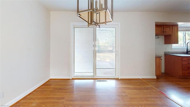 400 Ticonderoga Rd, Virginia Beach, VA 23462 - unfurnished dining area with light wood-style floors and baseboards