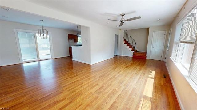 400 Ticonderoga Rd, Virginia Beach, VA 23462 - unfurnished living room featuring light wood finished floors, plenty of natural light, stairs, and a chandelier