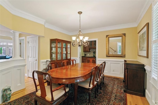 209 St Cuthbert, Williamsburg, VA 23188 - dining space with a decorative wall, a chandelier, ornamental molding, light wood-type flooring, and wainscoting