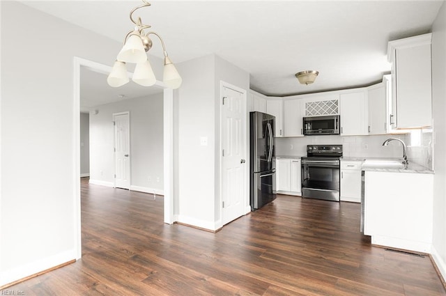 160 Ridge Rd, Poquoson, VA 23662 - kitchen with appliances with stainless steel finishes, light countertops, dark wood finished floors, backsplash, and white cabinets
