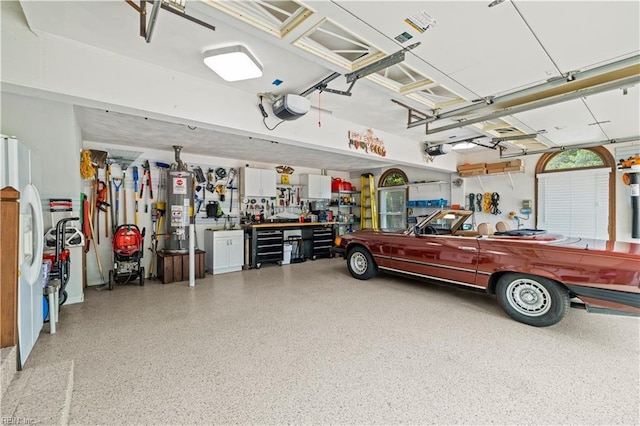 1604 Tether Keep, Virginia Beach, VA 23454 - garage featuring a workshop area, a garage door opener, gas water heater, and white refrigerator with ice dispenser