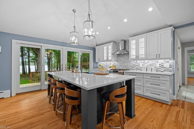 1405 Gravatt Ln, Virginia Beach, VA 23454 - kitchen with wall chimney exhaust hood, light countertops, lofted ceiling, decorative backsplash, and white cabinetry
