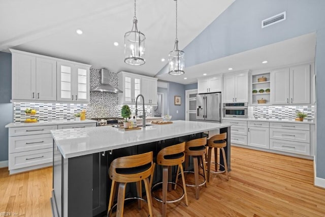 1405 Gravatt Ln, Virginia Beach, VA 23454 - kitchen with stainless steel appliances, wall chimney range hood, tasteful backsplash, white cabinets, and recessed lighting