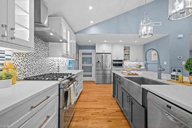 1405 Gravatt Ln, Virginia Beach, VA 23454 - kitchen featuring stainless steel appliances, wall chimney range hood, white cabinetry, light countertops, and tasteful backsplash