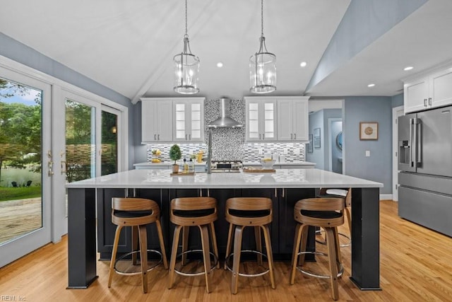 1405 Gravatt Ln, Virginia Beach, VA 23454 - kitchen with high end refrigerator, wall chimney exhaust hood, lofted ceiling, decorative backsplash, and a kitchen island with sink