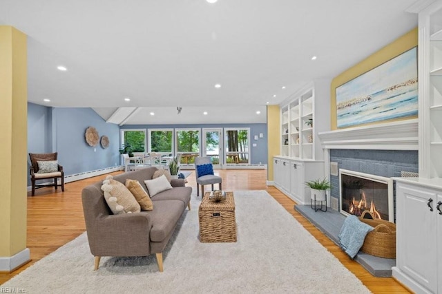 1405 Gravatt Ln, Virginia Beach, VA 23454 - living area with light wood finished floors, a glass covered fireplace, recessed lighting, built in shelves, and a baseboard radiator