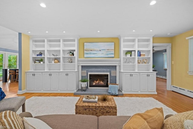 1405 Gravatt Ln, Virginia Beach, VA 23454 - living room featuring baseboard heating, light wood-style floors, a glass covered fireplace, and recessed lighting