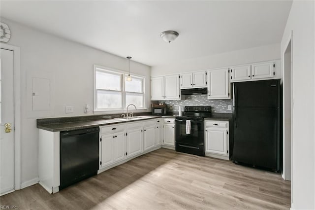 385 Susan Constant Dr, Newport News, VA 23608 - kitchen featuring black appliances, under cabinet range hood, dark countertops, white cabinets, and light wood finished floors