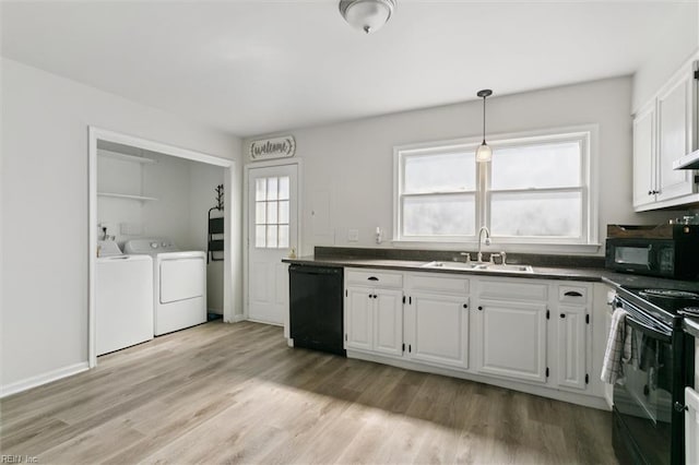 385 Susan Constant Dr, Newport News, VA 23608 - kitchen with black appliances, washer and clothes dryer, dark countertops, and white cabinetry