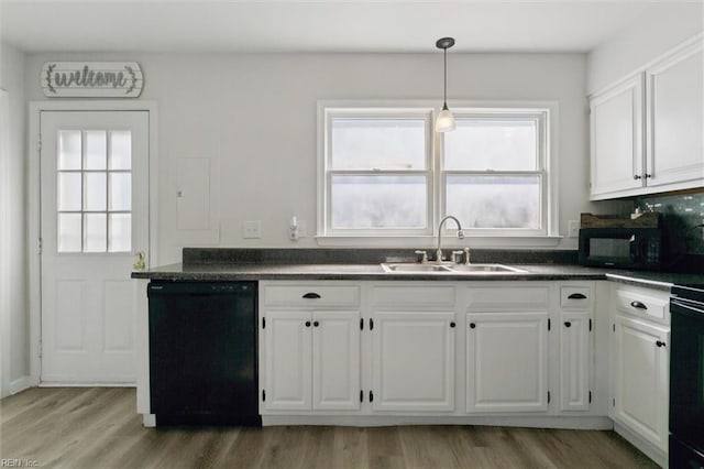 385 Susan Constant Dr, Newport News, VA 23608 - kitchen featuring black appliances, dark countertops, white cabinetry, and healthy amount of natural light