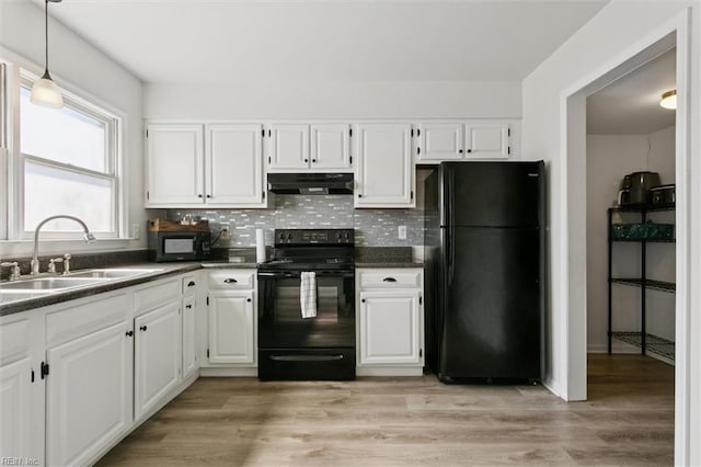 385 Susan Constant Dr, Newport News, VA 23608 - kitchen featuring black appliances, under cabinet range hood, dark countertops, white cabinetry, and backsplash