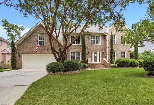 1832 Tree Line Rd, Virginia Beach, VA 23454 - view of front of home featuring an attached garage, driveway, brick siding, and a front lawn