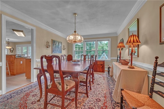 1832 Tree Line Rd, Virginia Beach, VA 23454 - dining space featuring wainscoting, a chandelier, light wood-style floors, and ornamental molding