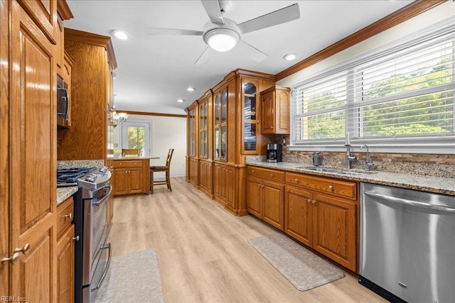 1309 Taft Rd, Chesapeake, VA 23322 - kitchen with stainless steel appliances, ornamental molding, brown cabinets, light wood-type flooring, and light stone counters