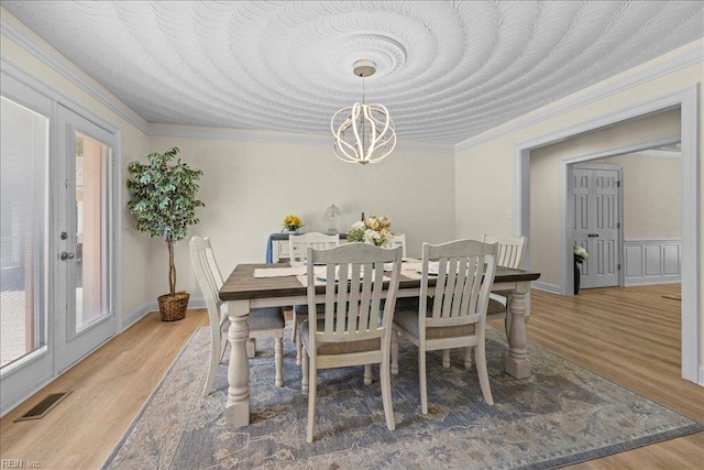 1309 Taft Rd, Chesapeake, VA 23322 - dining space with a chandelier, light wood finished floors, and crown molding