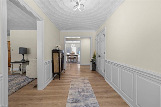 1309 Taft Rd, Chesapeake, VA 23322 - corridor with a chandelier, ornamental molding, wainscoting, and light wood-style flooring