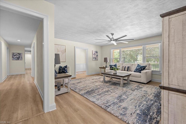 1309 Taft Rd, Chesapeake, VA 23322 - living room featuring a ceiling fan, wood finished floors, and a textured ceiling