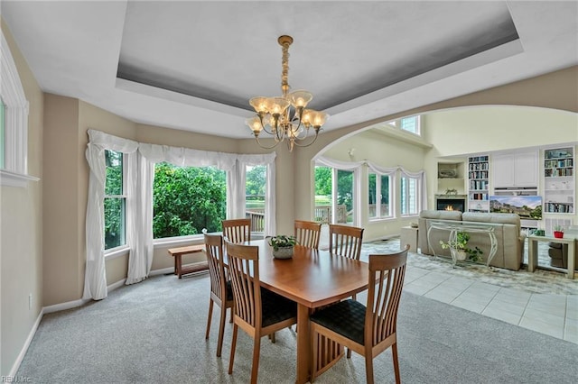 3541 Byrn Brae Dr, Virginia Beach, VA 23464 - dining area featuring a tray ceiling, light colored carpet, a chandelier, and baseboards