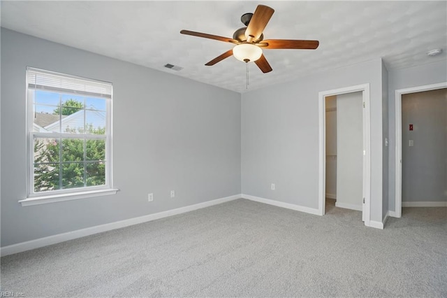 5217 Maracas Arch Arch Unit 50, Virginia Beach, VA 23462 - unfurnished bedroom featuring a spacious closet, carpet, ceiling fan, and a closet