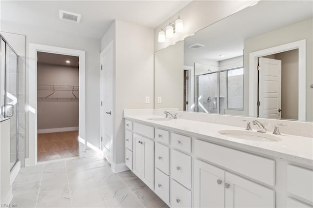 108 Robert Bruce Rd, Poquoson, VA 23662 - full bathroom with a stall shower, double vanity, marble look tile flooring, and a walk in closet