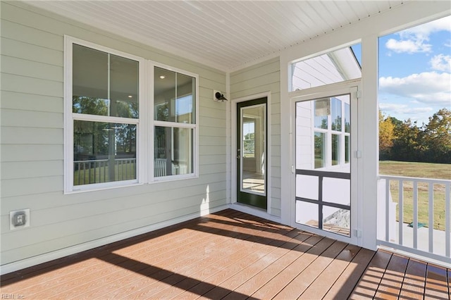 108 Robert Bruce Rd, Poquoson, VA 23662 - unfurnished sunroom featuring a deck, wood-type flooring, plenty of natural light, and wooden walls