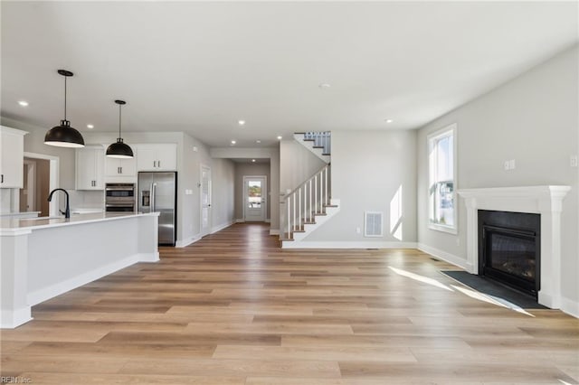 108 Robert Bruce Rd, Poquoson, VA 23662 - kitchen with appliances with stainless steel finishes, open floor plan, light countertops, white cabinets, and recessed lighting