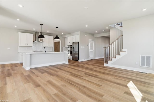 108 Robert Bruce Rd, Poquoson, VA 23662 - kitchen with wall chimney range hood, stainless steel fridge, recessed lighting, light countertops, and white cabinets