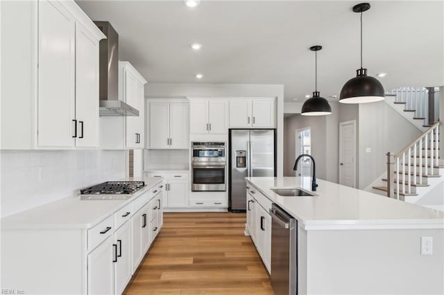 108 Robert Bruce Rd, Poquoson, VA 23662 - kitchen with appliances with stainless steel finishes, wall chimney range hood, recessed lighting, light countertops, and light wood finished floors