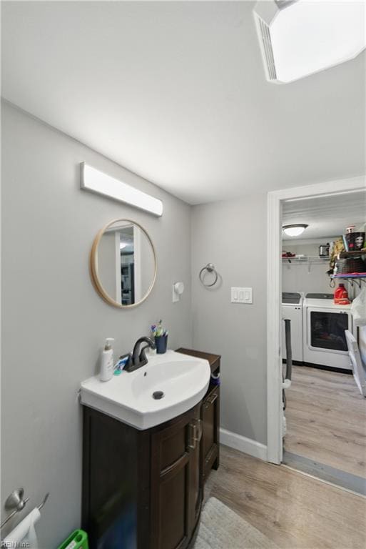 313 Saint James Ave, Suffolk, VA 23434 - bathroom with washing machine and dryer, wood finished floors, and vanity