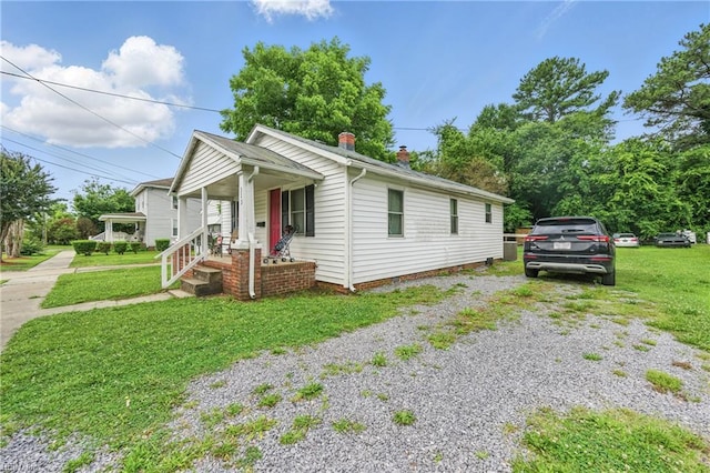 313 Saint James Ave, Suffolk, VA 23434 - view of front of home with a front yard, driveway, and a chimney