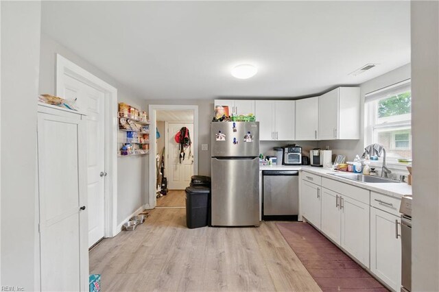 313 Saint James Ave, Suffolk, VA 23434 - kitchen with appliances with stainless steel finishes, light wood-style floors, light countertops, and white cabinets