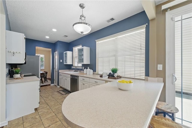 4 Angelia Way, Hampton, VA 23663 - kitchen featuring stainless steel appliances, white cabinetry, a peninsula, light countertops, and light tile patterned flooring