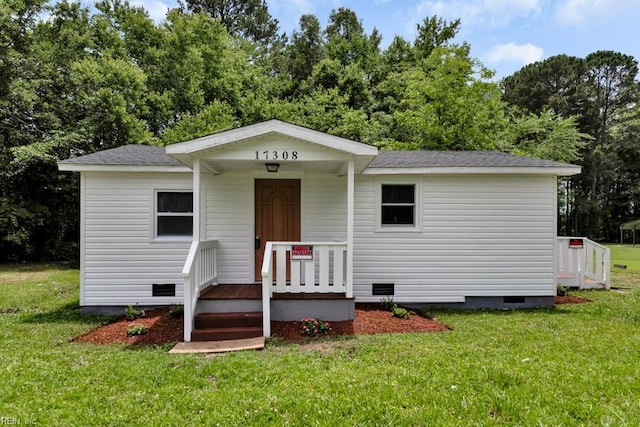 17308 Pittman Rd, Boykins, VA 23827 - bungalow-style home featuring crawl space, a front yard, roof with shingles, and view of scattered trees