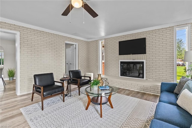 1309 Wickham Ave, Newport News, VA 23607 - living area with brick wall, plenty of natural light, a ceiling fan, wood finished floors, and a fireplace